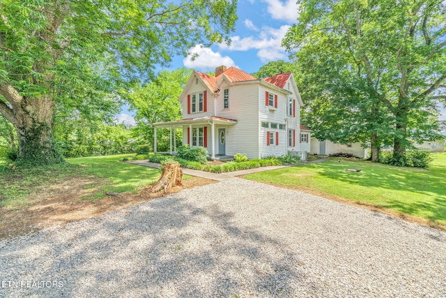 2115 Aaron Ct, Sevierville, TN 37876 - victorian house featuring a chimney, covered porch, and a front lawn