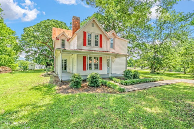 2115 Aaron Ct, Sevierville, TN 37876 - view of front of house featuring covered porch, a chimney, and a front yard