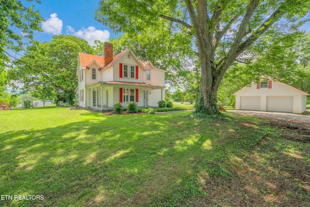 2115 Aaron Ct, Sevierville, TN 37876 - view of front of home featuring a chimney, a garage, a front lawn, covered porch, and an outdoor structure