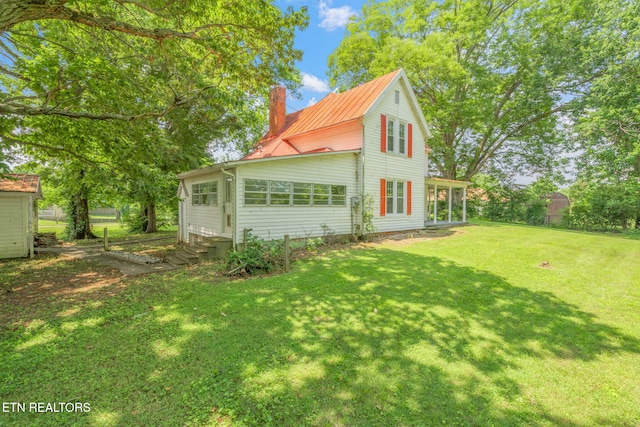 2115 Aaron Ct, Sevierville, TN 37876 - view of home's exterior with a chimney, entry steps, and a yard