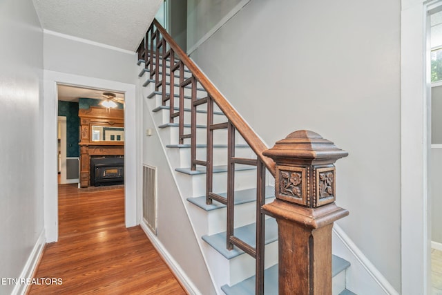 2115 Aaron Ct, Sevierville, TN 37876 - stairway with wood finished floors, a textured ceiling, and a fireplace