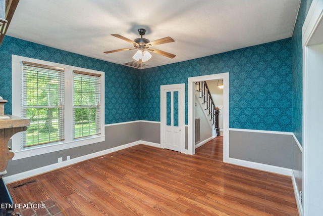 2115 Aaron Ct, Sevierville, TN 37876 - unfurnished room featuring ceiling fan, wood finished floors, stairs, and wallpapered walls