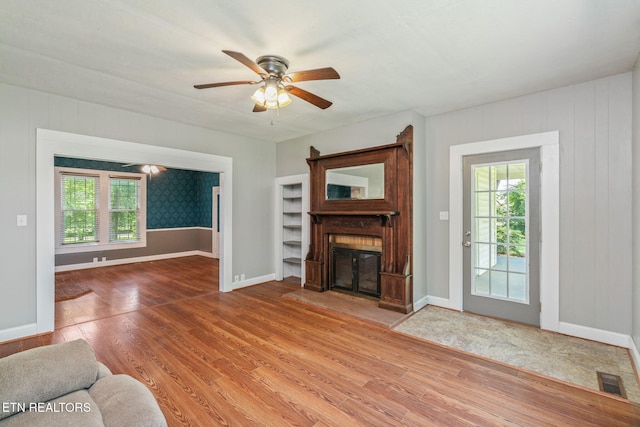 2115 Aaron Ct, Sevierville, TN 37876 - living room with wood finished floors, healthy amount of natural light, a glass covered fireplace, and ceiling fan