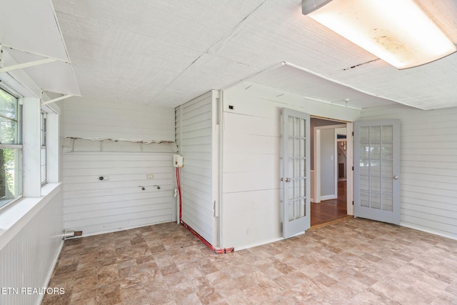 2115 Aaron Ct, Sevierville, TN 37876 - unfurnished room featuring wood walls, french doors, and stone finish flooring