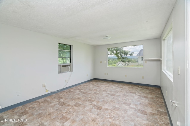 2115 Aaron Ct, Sevierville, TN 37876 - empty room with plenty of natural light, cooling unit, and a textured ceiling