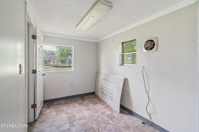 2115 Aaron Ct, Sevierville, TN 37876 - unfurnished bedroom featuring multiple windows, a textured ceiling, and stone finish floors