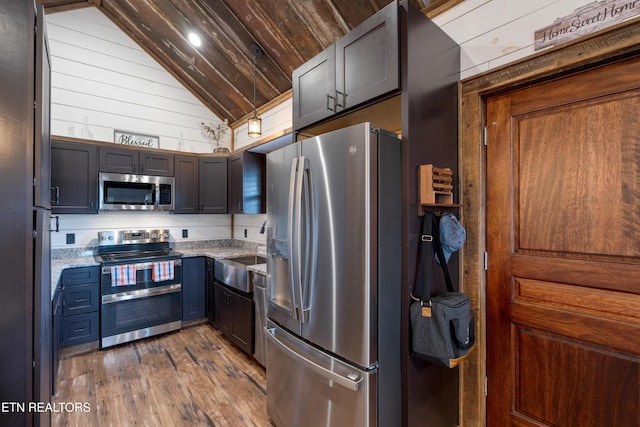 1023 Timberlake Cir, Sevierville, TN 37876 - kitchen with appliances with stainless steel finishes, vaulted ceiling, light stone counters, dark wood-style flooring, and wood ceiling