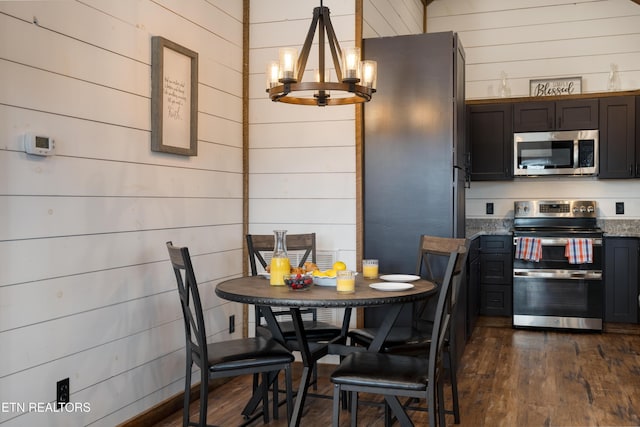 1023 Timberlake Cir, Sevierville, TN 37876 - dining room with a chandelier, wood walls, and dark wood finished floors