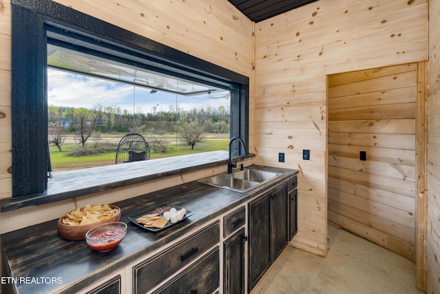 1023 Timberlake Cir, Sevierville, TN 37876 - kitchen featuring dark countertops, wood walls, and concrete flooring