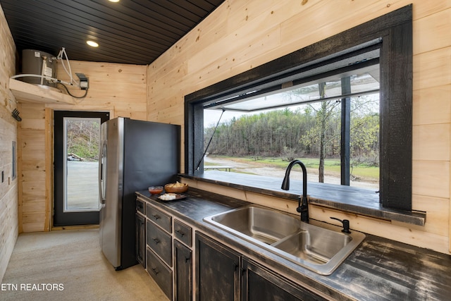 1023 Timberlake Cir, Sevierville, TN 37876 - kitchen with freestanding refrigerator, wooden walls, dark countertops, plenty of natural light, and wood ceiling