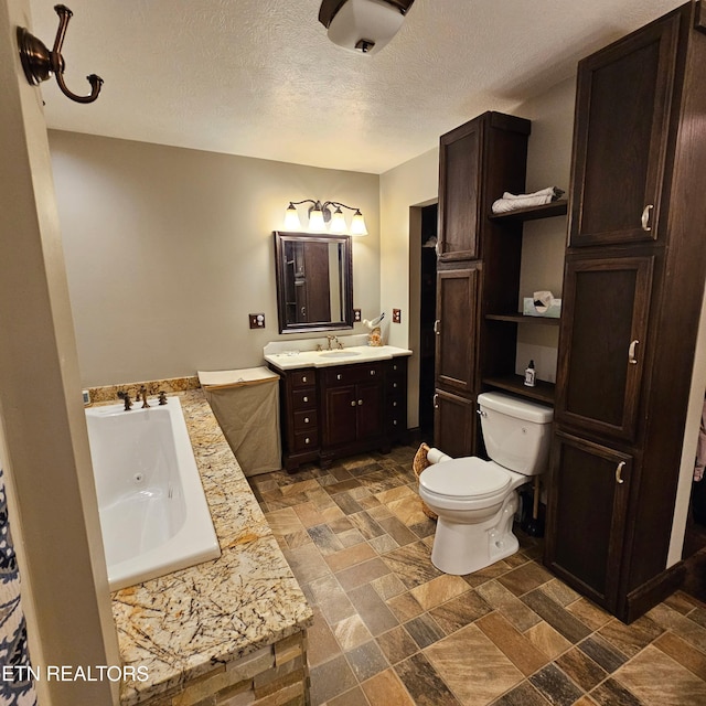 1100 Mill Branch Rd, Huntsville, TN 37756 - bathroom featuring vanity, a whirlpool tub, a textured ceiling, and stone tile flooring