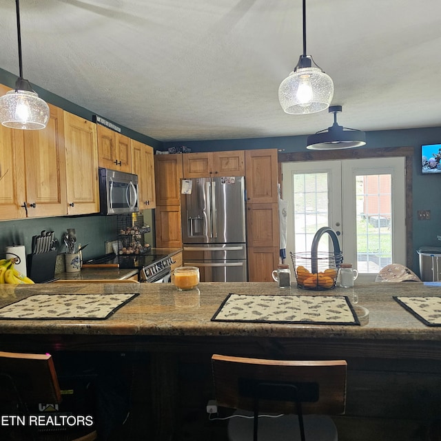1100 Mill Branch Rd, Huntsville, TN 37756 - kitchen with stainless steel appliances, french doors, decorative light fixtures, and a peninsula