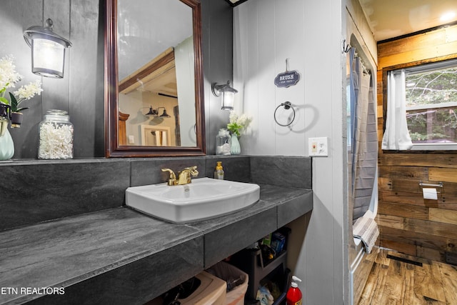 816 Thorn Grove Pike, Strawberry Plains, TN 37871 - bathroom with wood finished floors, vanity, wood walls, and curtained shower