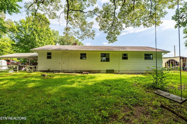 816 Thorn Grove Pike, Strawberry Plains, TN 37871 - back of house with a lawn, a chimney, and a detached carport