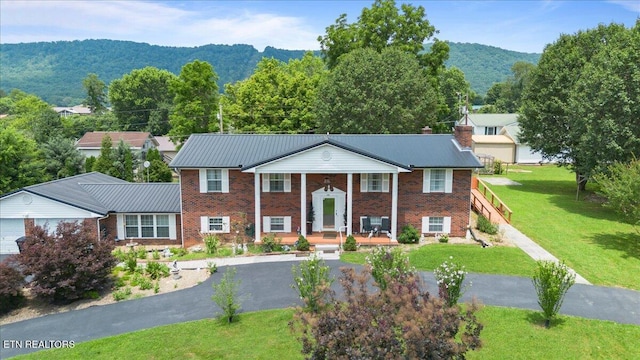 116 Oak St, Jacksboro, TN 37757 - raised ranch with a porch, a mountain view, brick siding, and a front yard