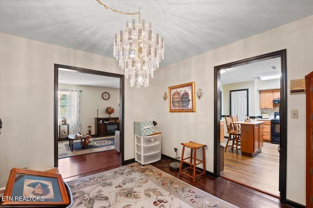 116 Oak St, Jacksboro, TN 37757 - hallway featuring wood finished floors and a chandelier
