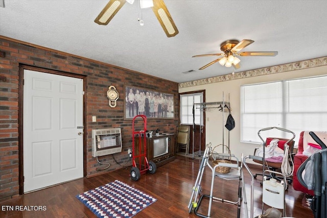 116 Oak St, Jacksboro, TN 37757 - exercise room with heating unit, ceiling fan, brick wall, dark wood-style flooring, and a textured ceiling