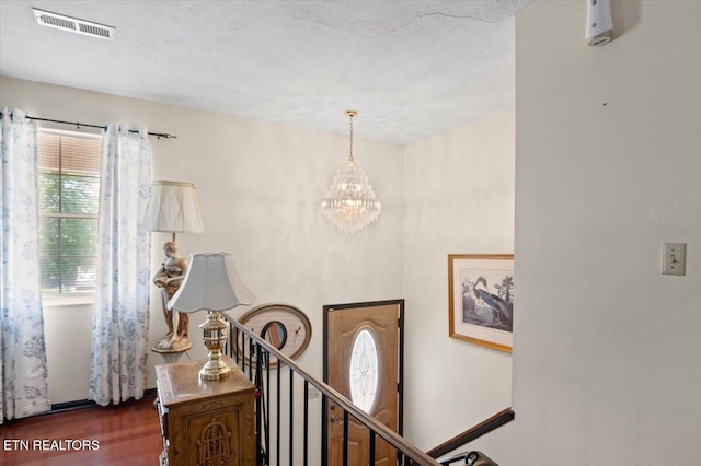 116 Oak St, Jacksboro, TN 37757 - staircase with a chandelier, wood finished floors, and a textured ceiling