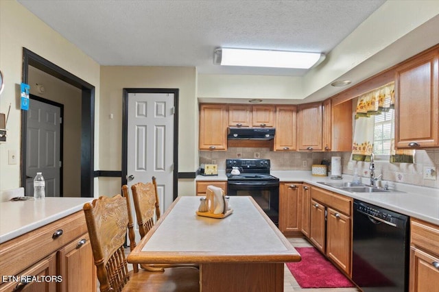116 Oak St, Jacksboro, TN 37757 - kitchen featuring black appliances, under cabinet range hood, backsplash, light countertops, and a textured ceiling