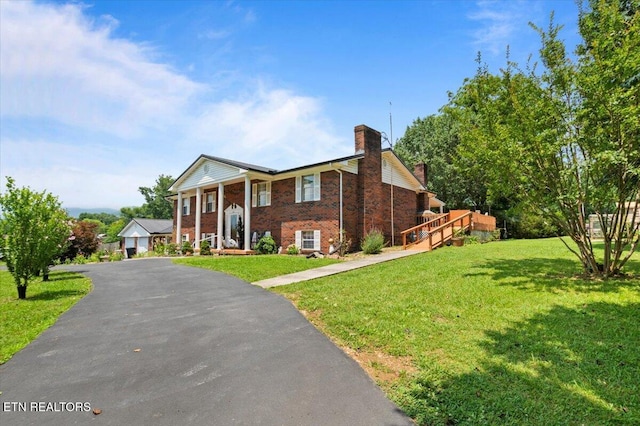 116 Oak St, Jacksboro, TN 37757 - view of front of house with a chimney, brick siding, a front lawn, and covered porch