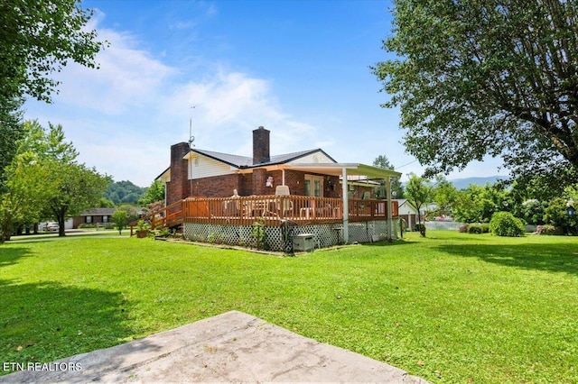 116 Oak St, Jacksboro, TN 37757 - rear view of property with a chimney, a yard, a wooden deck, and a patio