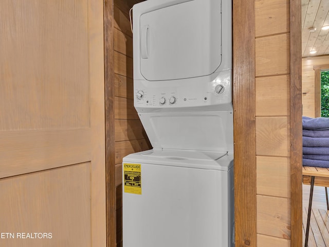 1940 Smoky Cove Rd, Sevierville, TN 37876 - laundry room with stacked washing machine and dryer and wooden walls