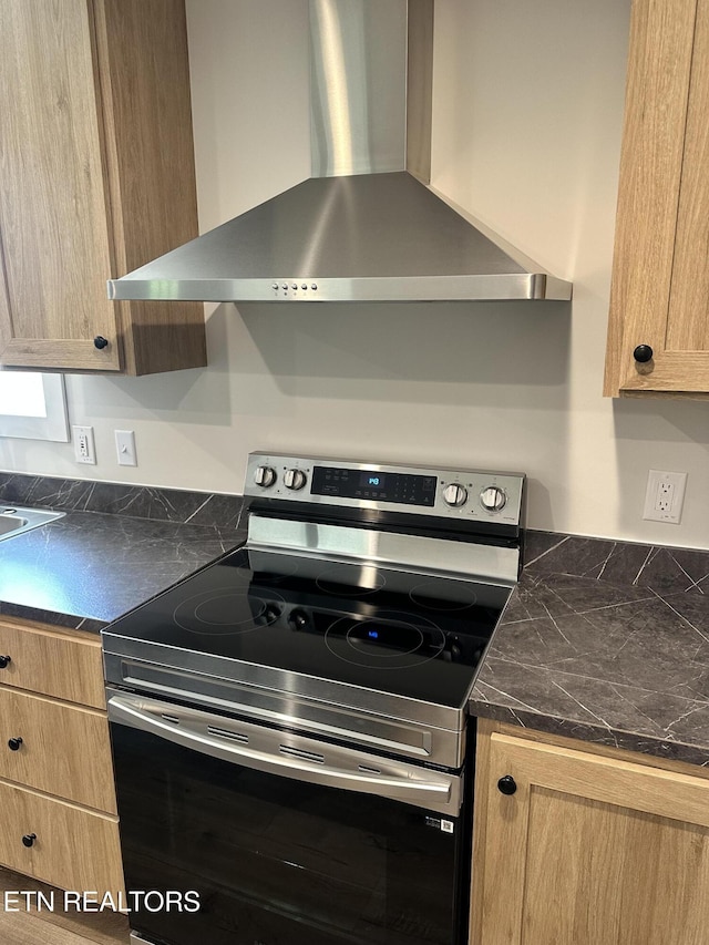 9556 Crisman Rd, Heiskell, TN 37754 - kitchen with stainless steel range with electric cooktop, wall chimney exhaust hood, light brown cabinetry, and tile countertops
