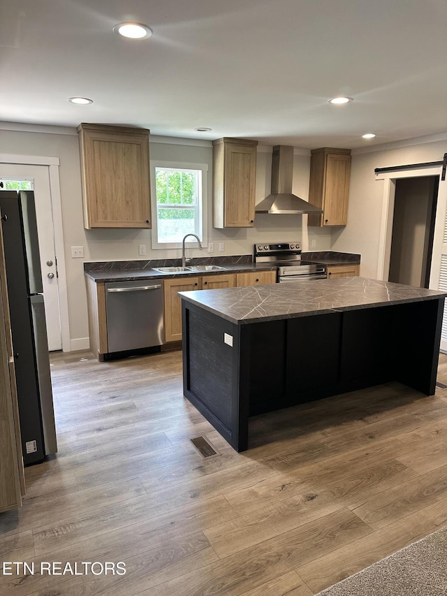 9556 Crisman Rd, Heiskell, TN 37754 - kitchen with wall chimney exhaust hood, appliances with stainless steel finishes, a barn door, recessed lighting, and a kitchen island