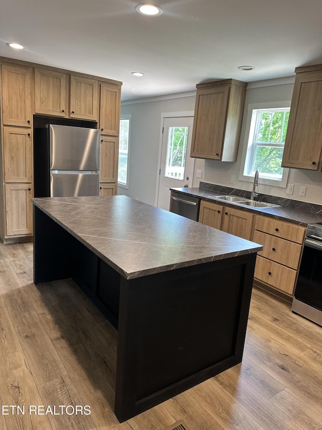9556 Crisman Rd, Heiskell, TN 37754 - kitchen featuring stainless steel appliances, dark countertops, a center island, healthy amount of natural light, and crown molding
