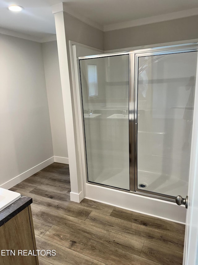 9556 Crisman Rd, Heiskell, TN 37754 - bathroom with a stall shower, vanity, crown molding, wood finished floors, and recessed lighting