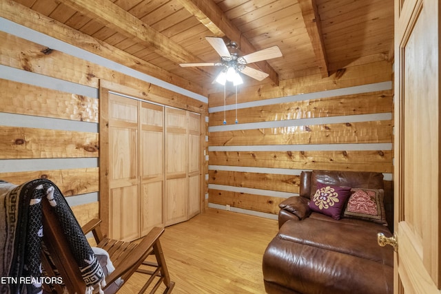 721 Leisure Way, Newport, TN 37821 - living area featuring wood walls, a wooden ceiling with exposed beams, a ceiling fan, and light wood-type flooring
