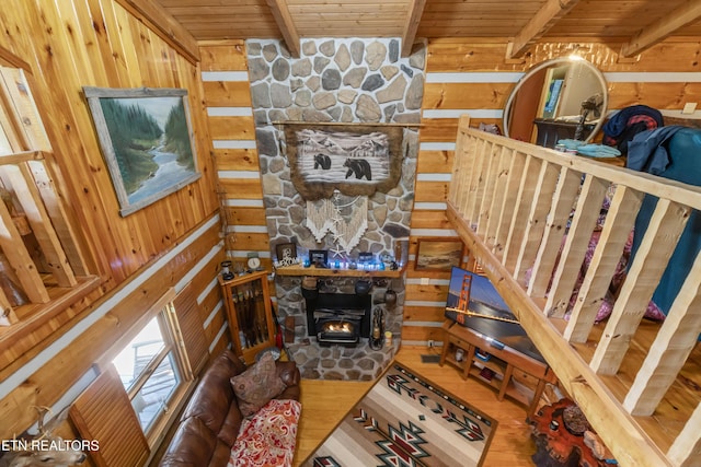 721 Leisure Way, Newport, TN 37821 - living area featuring a wood ceiling with exposed beams, wooden walls, wood finished floors, and a wood stove