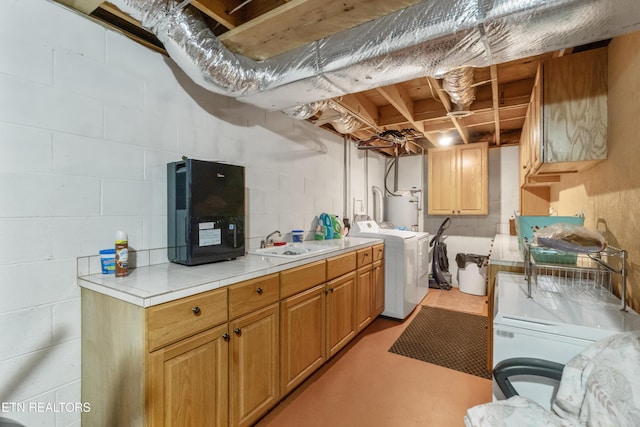 721 Leisure Way, Newport, TN 37821 - laundry room featuring water heater, cabinet space, concrete block wall, and washer and clothes dryer