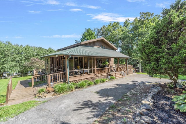 721 Leisure Way, Newport, TN 37821 - view of front of property with driveway, a metal roof, covered porch, and a sunroom