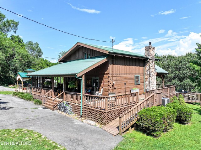 721 Leisure Way, Newport, TN 37821 - view of property exterior featuring a chimney, a metal roof, and covered porch