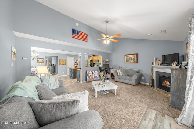 3701 Eliza Pointe Way, Knoxville, TN 37921 - living area with a glass covered fireplace, carpet floors, a ceiling fan, high vaulted ceiling, and a chandelier