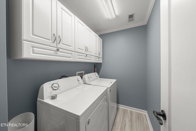 3701 Eliza Pointe Way, Knoxville, TN 37921 - washroom with cabinet space, washing machine and dryer, ornamental molding, and light wood finished floors