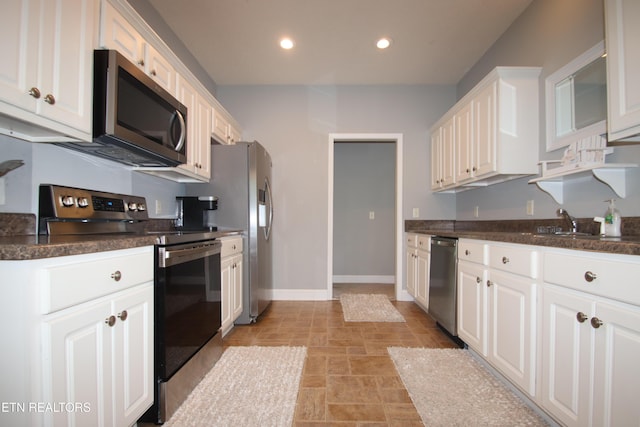 5843 Forest View Ln, Ooltewah, TN 37363 - kitchen with appliances with stainless steel finishes, stone finish flooring, white cabinetry, and recessed lighting