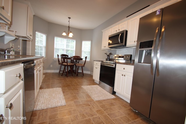 5843 Forest View Ln, Ooltewah, TN 37363 - kitchen featuring appliances with stainless steel finishes, dark countertops, white cabinetry, and a chandelier