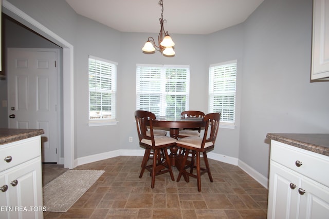 5843 Forest View Ln, Ooltewah, TN 37363 - dining area featuring stone finish floors, plenty of natural light, and a chandelier