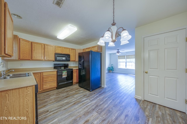 1709 Maple View Way Unit 4A, Knoxville, TN 37918 - kitchen with black appliances, a chandelier, light countertops, light wood-type flooring, and pendant lighting