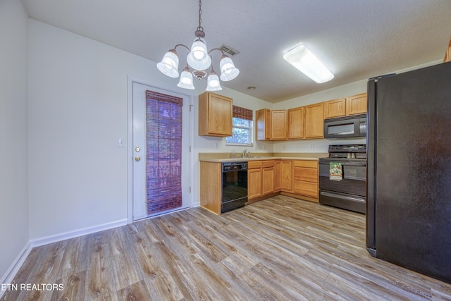 1709 Maple View Way Unit 4A, Knoxville, TN 37918 - kitchen featuring black appliances, light wood-type flooring, light countertops, and a chandelier
