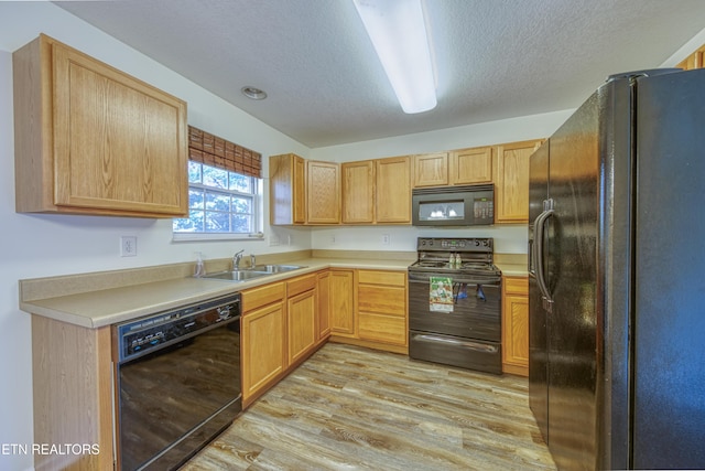 1709 Maple View Way Unit 4A, Knoxville, TN 37918 - kitchen featuring black appliances, light wood-type flooring, a textured ceiling, light countertops, and light brown cabinetry