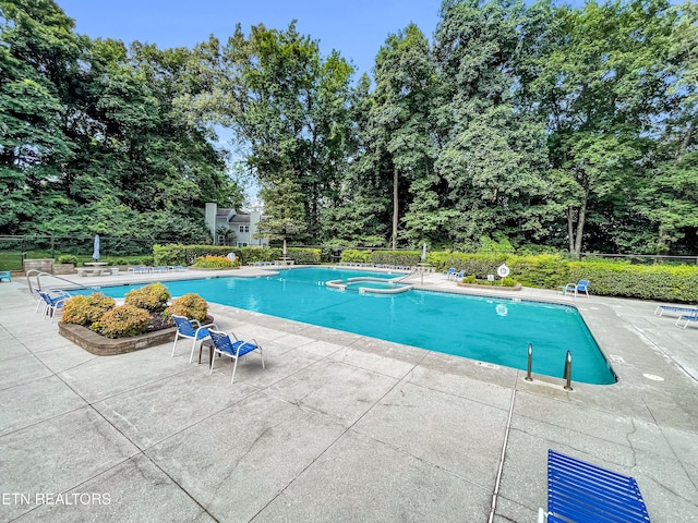 8707 Olde Colony Trl Unit 13, Knoxville, TN 37923 - view of pool featuring a patio area, a pool with connected hot tub, and view of scattered trees
