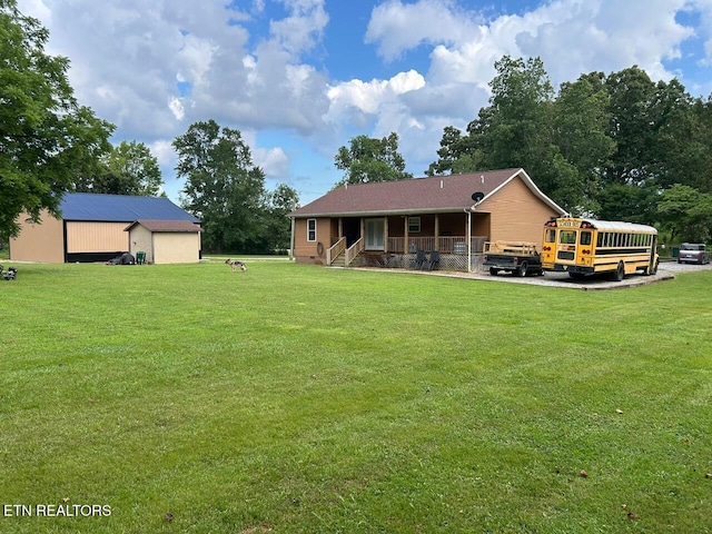 935 Pinetree Rd, Jamestown, TN 38556 - back of house with a yard, an outbuilding, and a porch