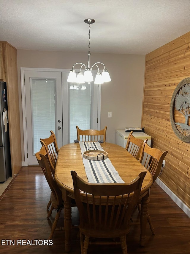 935 Pinetree Rd, Jamestown, TN 38556 - dining space with wood walls, dark wood finished floors, and a chandelier