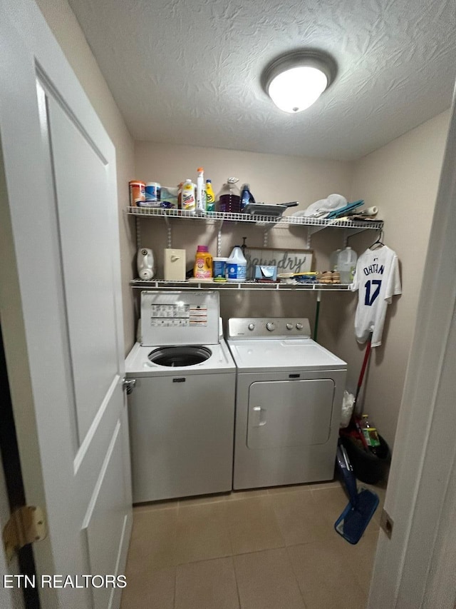935 Pinetree Rd, Jamestown, TN 38556 - laundry area featuring washer and dryer, tile patterned floors, and a textured ceiling