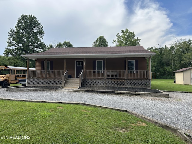 935 Pinetree Rd, Jamestown, TN 38556 - view of front of house with a porch, a front yard, and an outbuilding