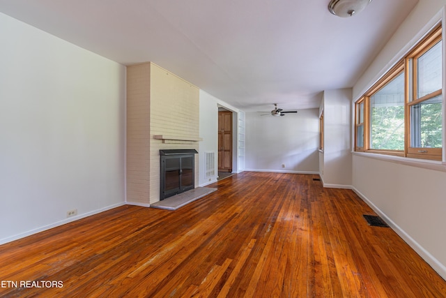 128 Orchard Ln, Oak Ridge, TN 37830 - unfurnished living room featuring hardwood / wood-style floors, a brick fireplace, and ceiling fan