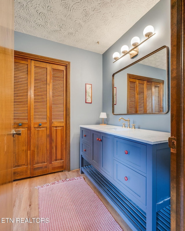 5122 Moody Dr, Kingsport, TN 37664 - bathroom with wood finished floors, vanity, and a textured ceiling